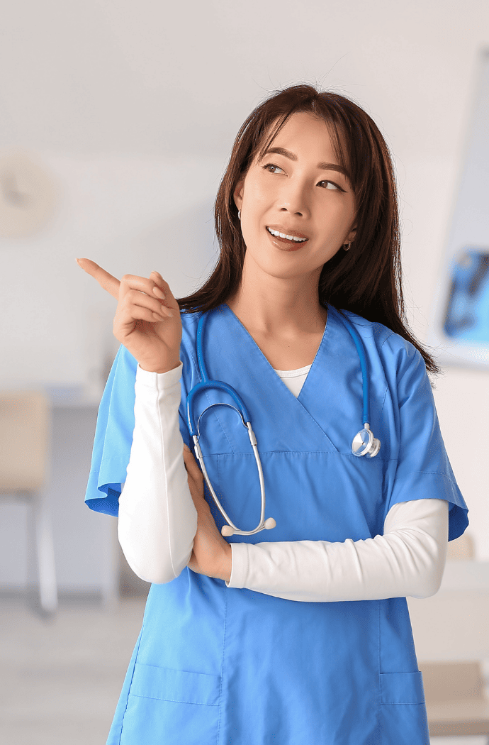 Nurse in medical scrubs pointing to the side in a bright healthcare environment